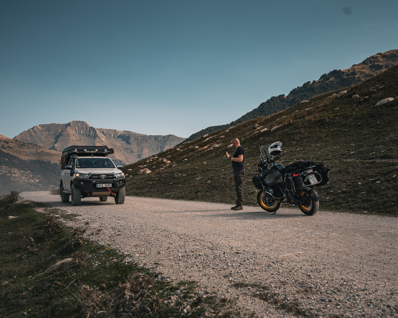 Rider and 4x4 meeting on a mountain track
