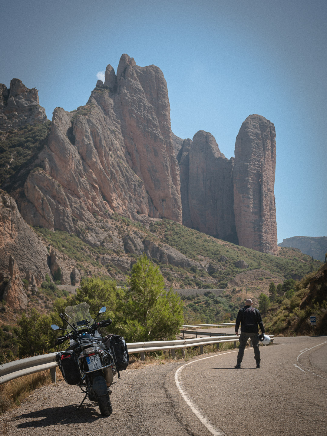 Rider below towering rock pillars
