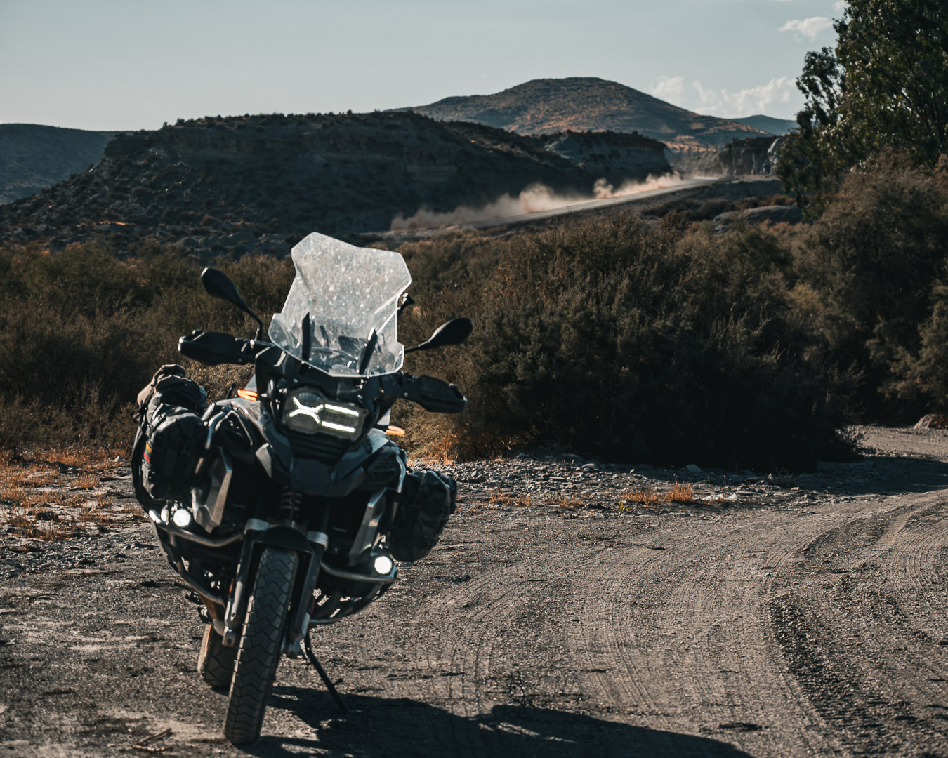 Bike on a dirt track with dust trail behind